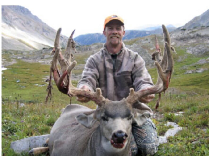 Hunter smiling while holding moose