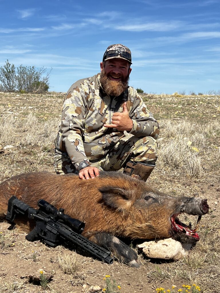 Hunter posing with boar